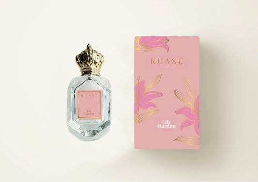 A bottle of Lily Garden perfume placed beside a its pale pink box.